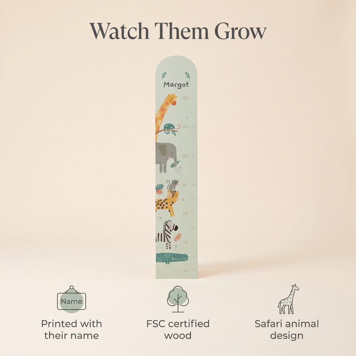 Child being measured against a personalised safari wooden growth chart