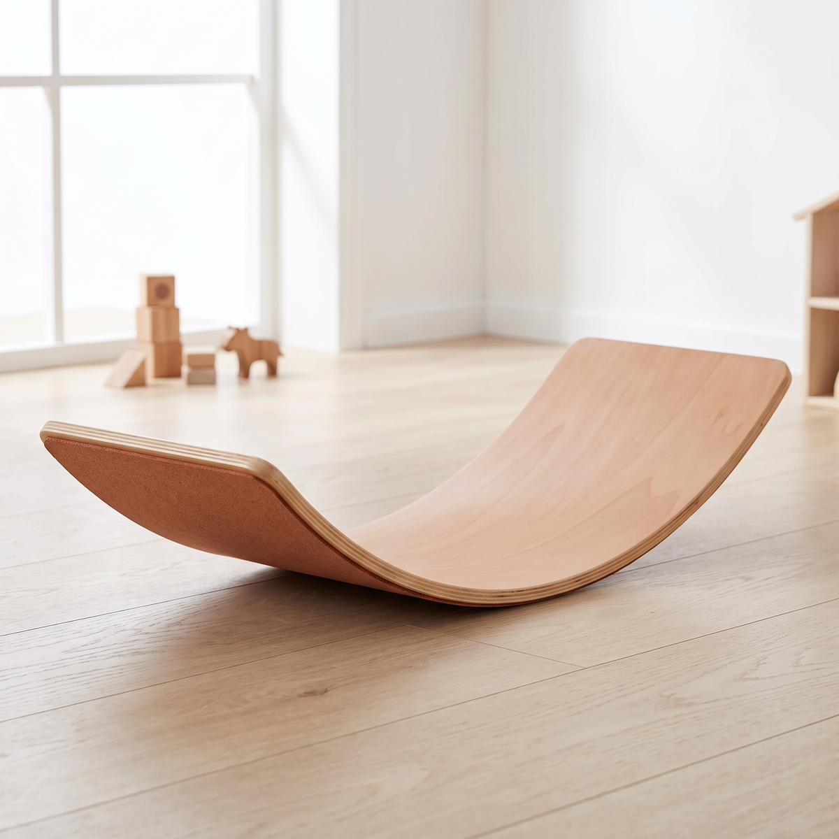 Wooden balance board with red brick felt backing in a bright Scandinavian kids room