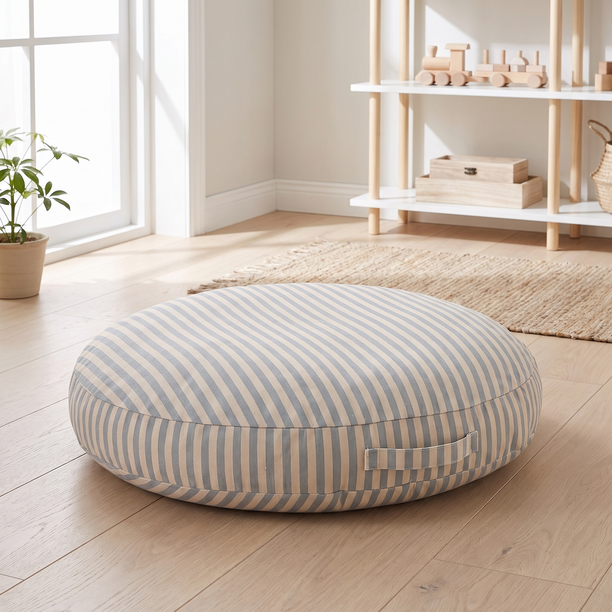 Blue striped kids floor cushion on a pale oak floor in a bright kids room