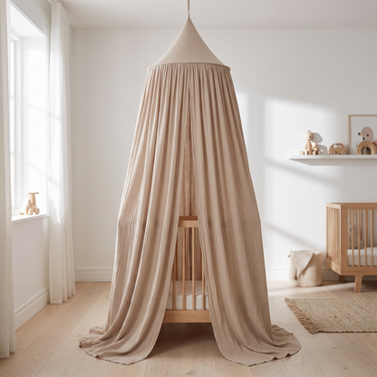 Nougat kids bed canopy hanging over a cot in a Scandinavian nursery