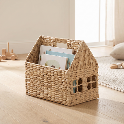 House shaped woven book storage basket in a bright Scandinavian kids room