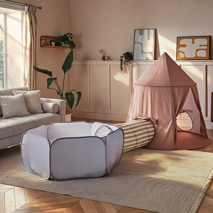 Pop-up tent, tunnel and ball pit set laid out in a modern family living room