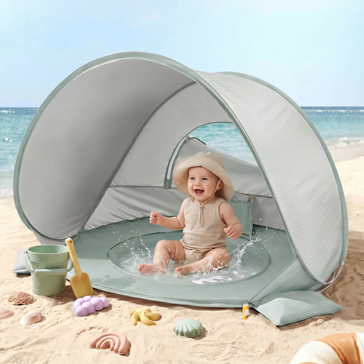 Baby sitting in the splash pool inside the shaded beach tent