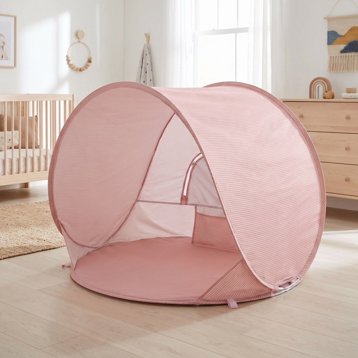 Fine-striped pop-up baby beach tent in a bright Scandinavian nursery