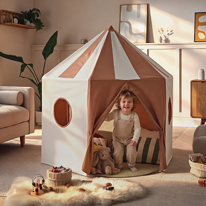 Child peeking out of the pavilion play tent door