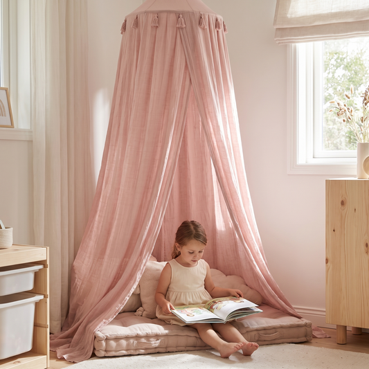 Child reading inside the dusty pink canopy