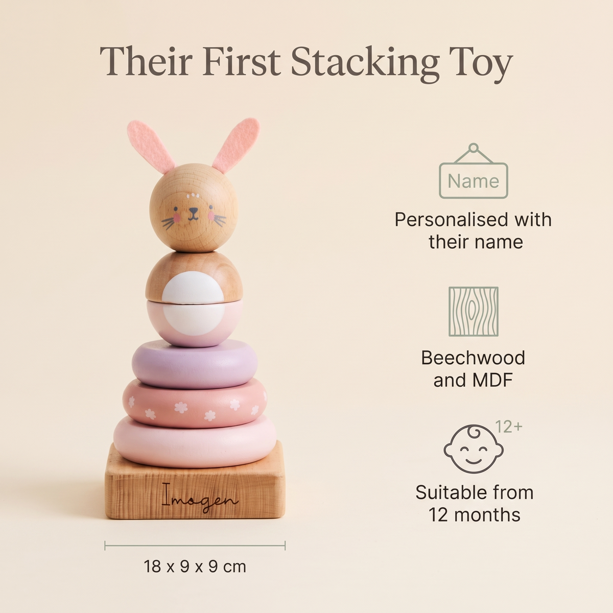 Baby playing with a personalised pink wooden bunny stacker