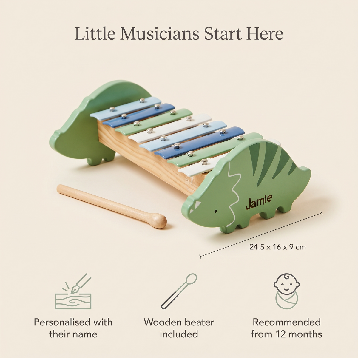 Toddler playing a personalised wooden dinosaur xylophone in a playroom