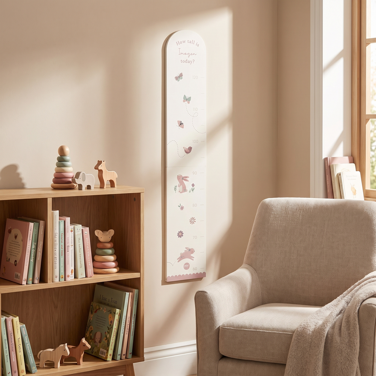 Close-up of woodland animal illustrations and name on wooden height chart