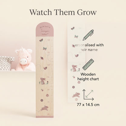 Child being measured against a personalised woodland height chart