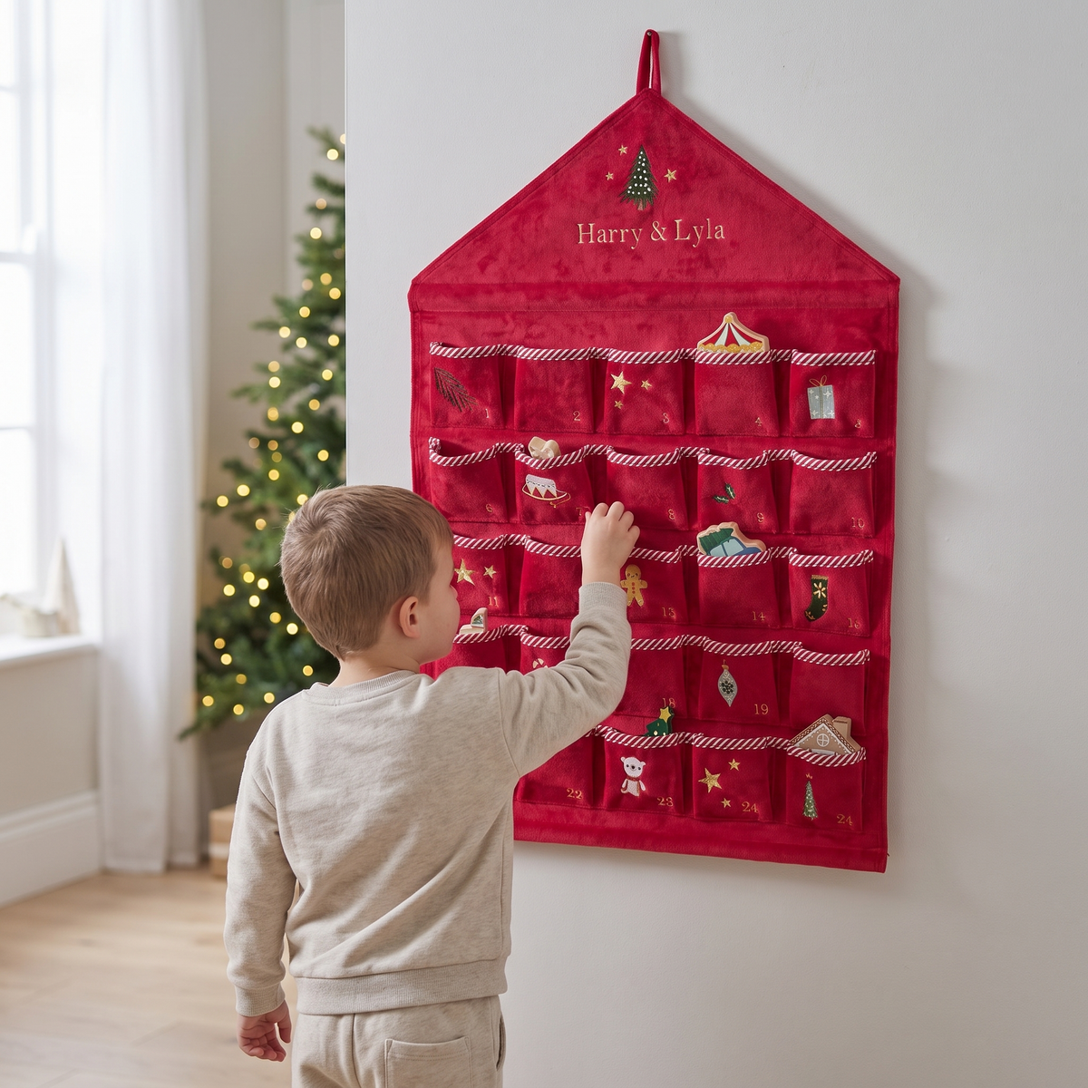 Red velvet advent calendar hanging on a wall in a festive living room