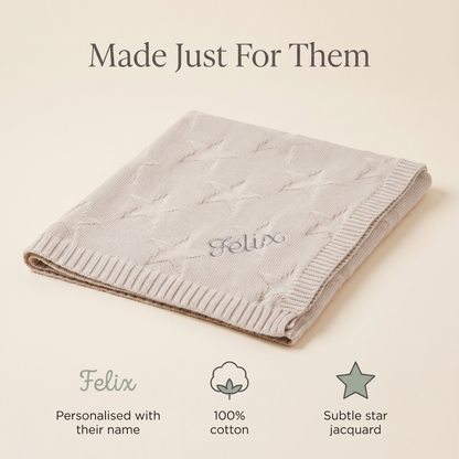 Baby wrapped in a personalised oatmeal star cotton blanket
