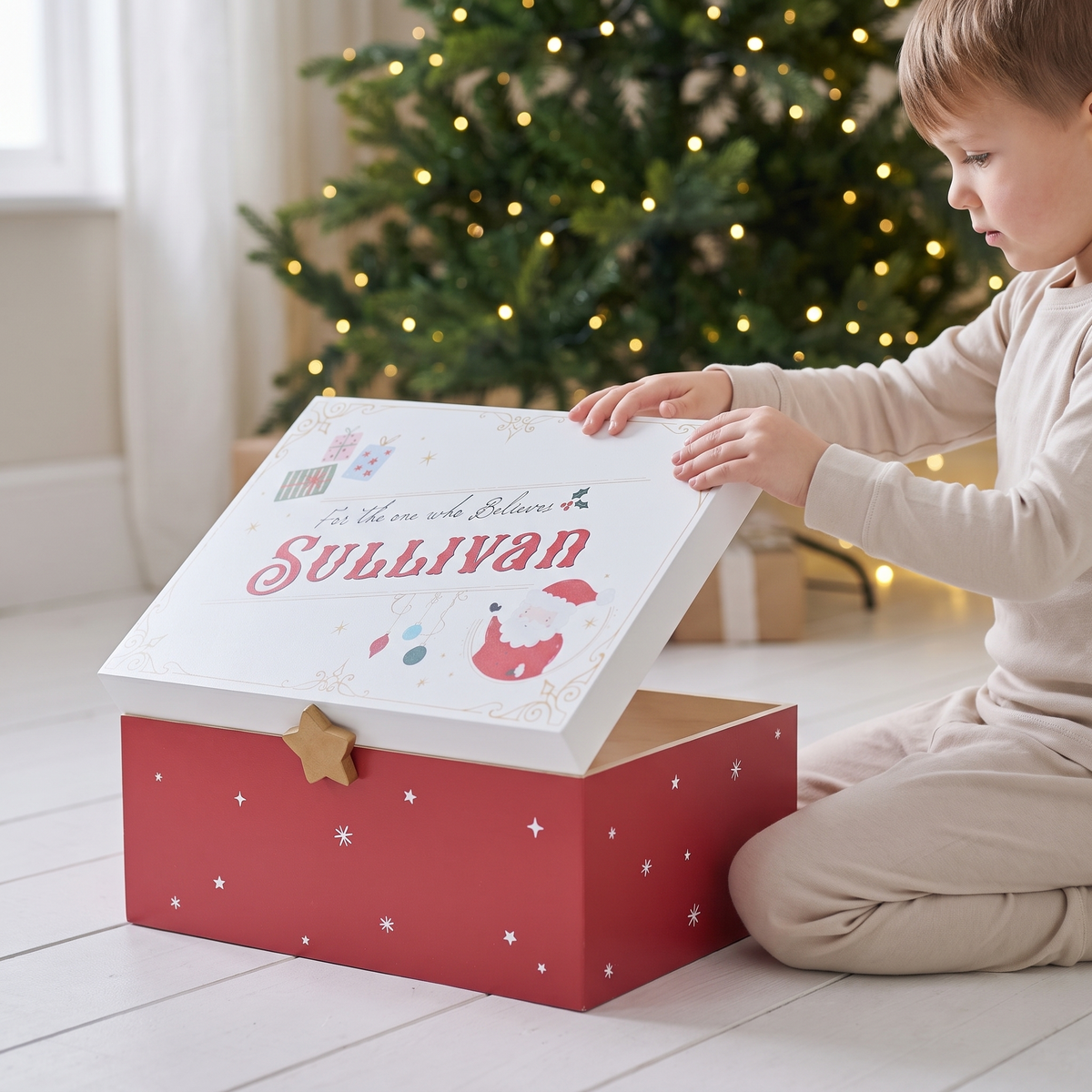 Wooden Christmas Eve box styled beside a Christmas tree in a family living room
