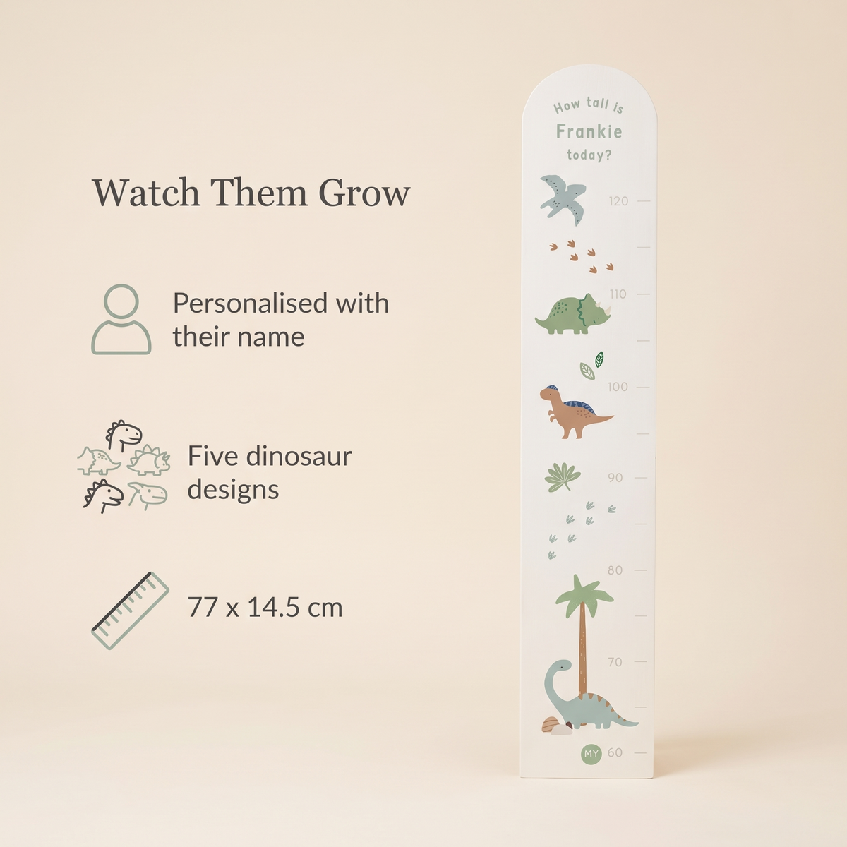 Child being measured against a personalised dinosaur wooden height chart