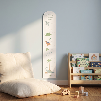 Dinosaur height chart styled in a child's bedroom with toys and soft furnishings