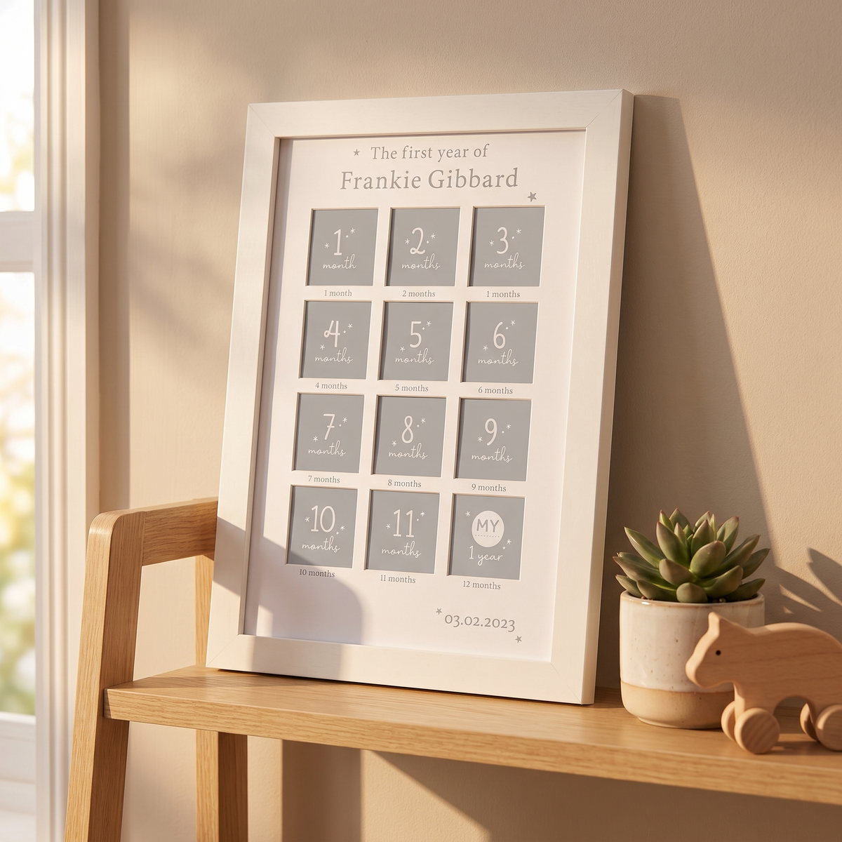 First year milestone photo frame styled on a nursery dresser