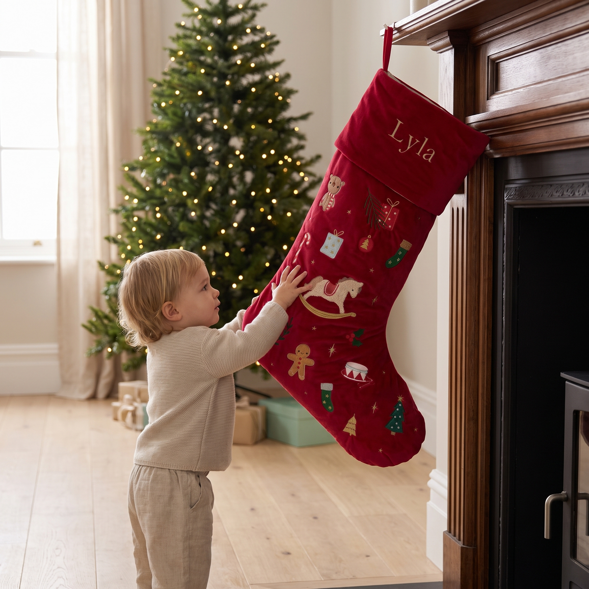 Large embroidered red velvet stocking hanging from a Christmas mantel