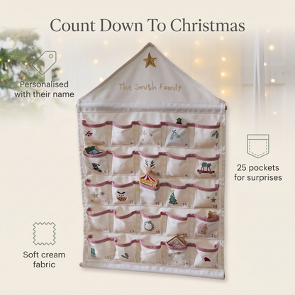 Child opening a pocket on a personalised cream advent calendar at Christmas