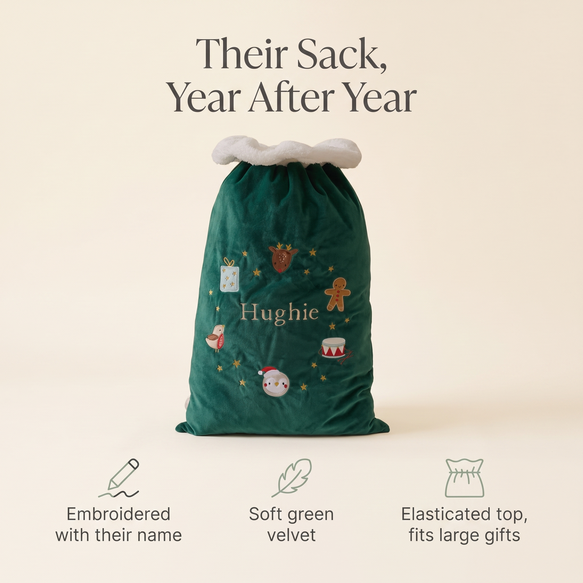 Child with a personalised green velvet Santa sack on Christmas morning