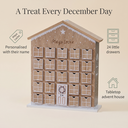Child opening a drawer on a personalised gingerbread advent house