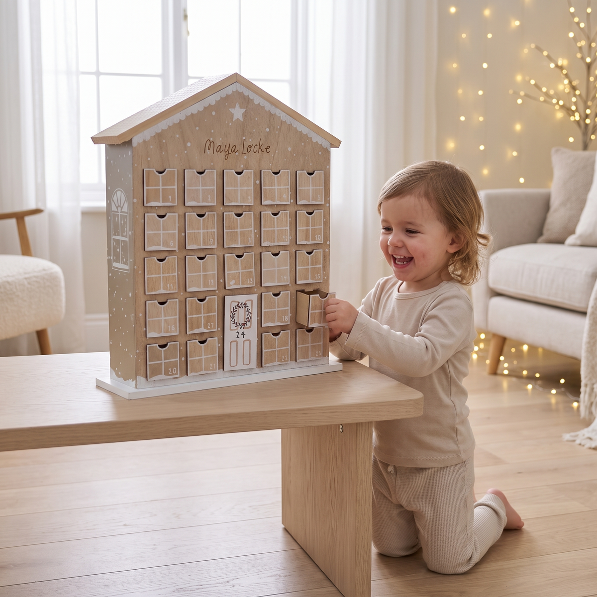 Gingerbread advent house styled on a mantel with Christmas decorations