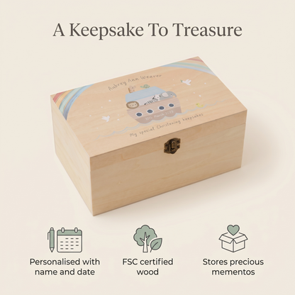 Personalised christening keepsake box on a dresser beside a cot