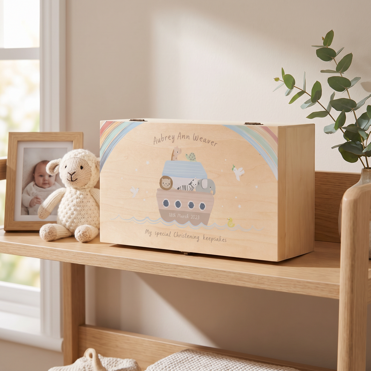 Noah's Ark wooden keepsake box styled with baby mementos in a soft nursery