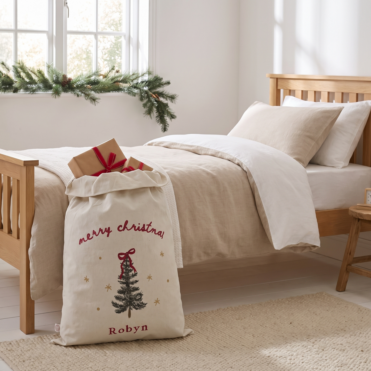 Close-up of Christmas tree motif and name on cream canvas Santa sack