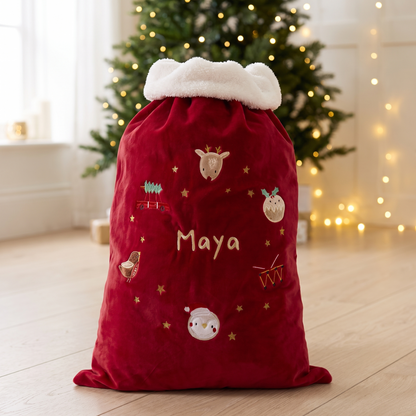Personalised red plush Santa sack with embroidered name and white fluffy trim