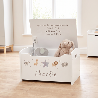 Personalised white safari animal wooden toy box with message on lid in a nursery