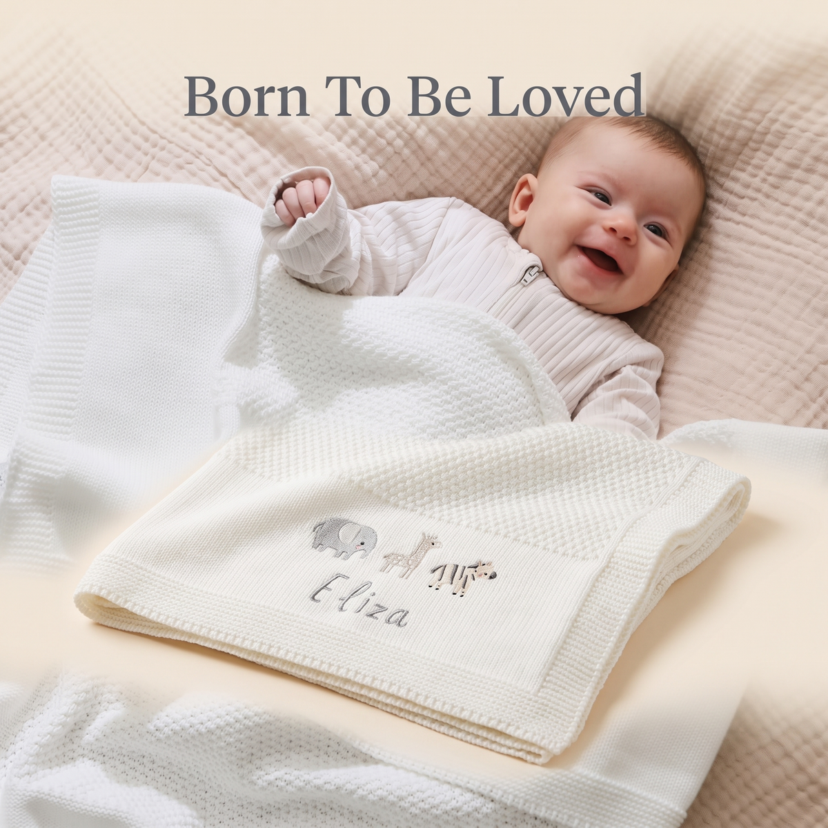 Newborn wrapped in a personalised ivory knitted shawl blanket