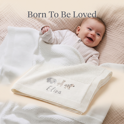 Newborn wrapped in a personalised ivory knitted shawl blanket