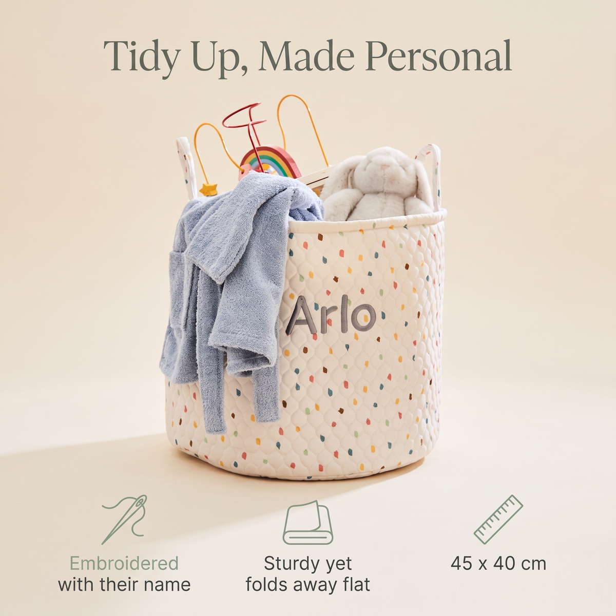 Personalised polka dot storage bag filled with toys in a playroom