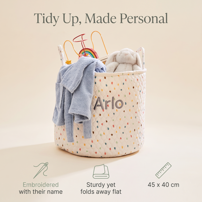 Personalised polka dot storage bag filled with toys in a playroom
