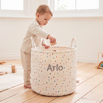 Rainbow polka dot personalised storage bag styled in a bright nursery