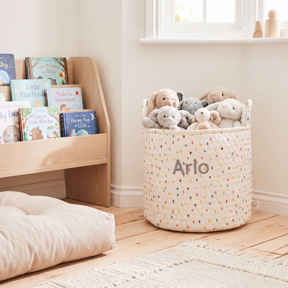 Close-up of embroidered name on polka dot nursery storage bag