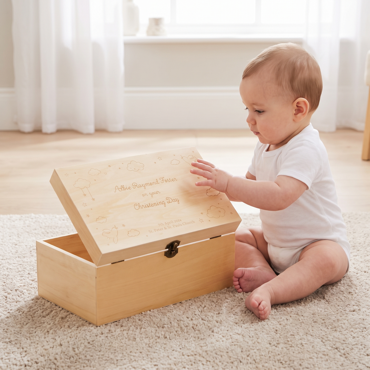 Engraved christening keepsake box styled on a nursery shelf