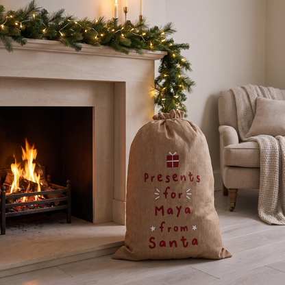 Close-up of red lettering and name on hessian Santa sack