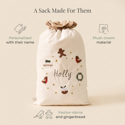 Child with a personalised cream Santa sack on Christmas morning
