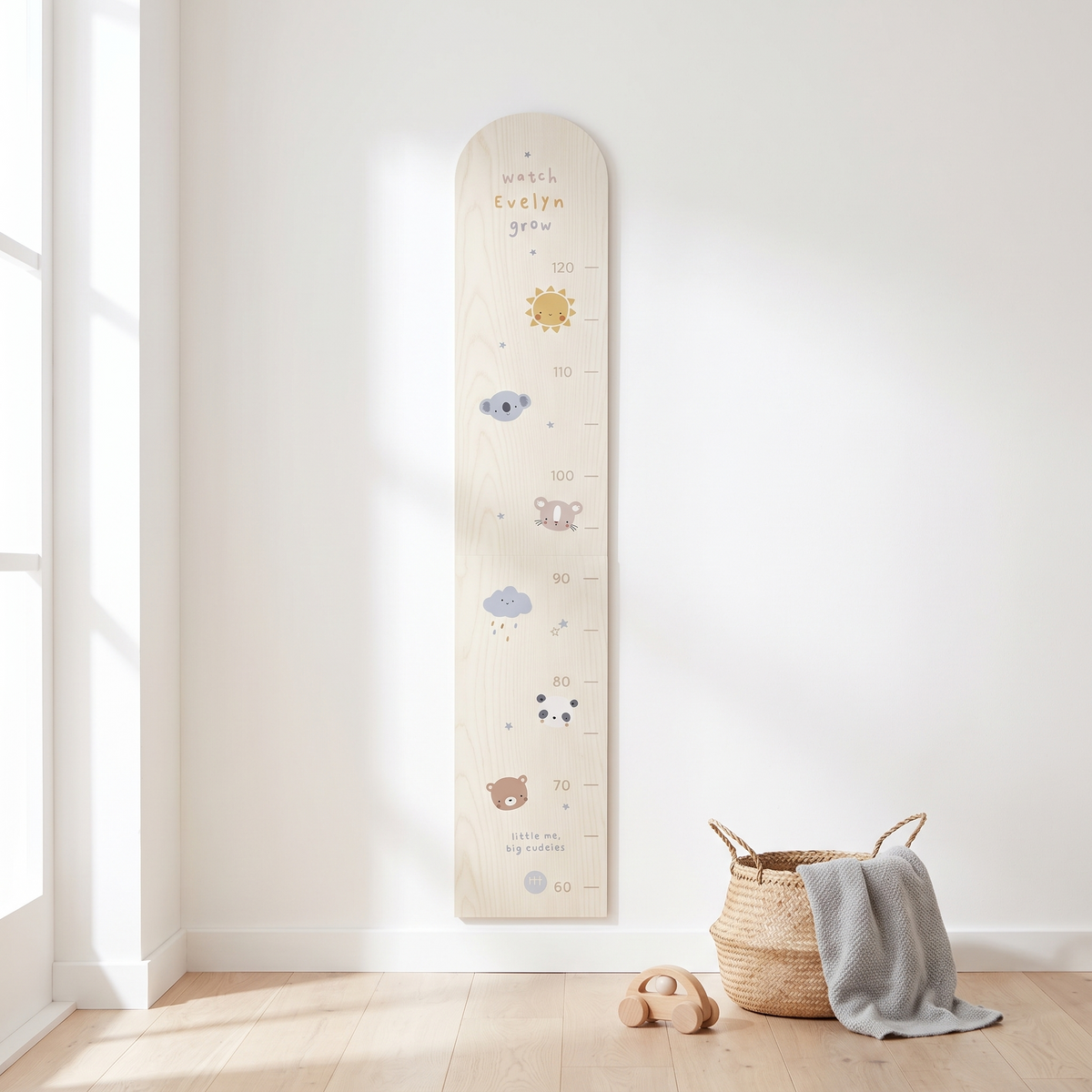 Personalised cream wooden height chart with monochrome animals on a nursery wall