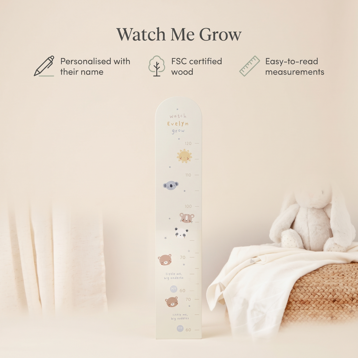 Child standing beside a personalised mono animal wooden growth chart