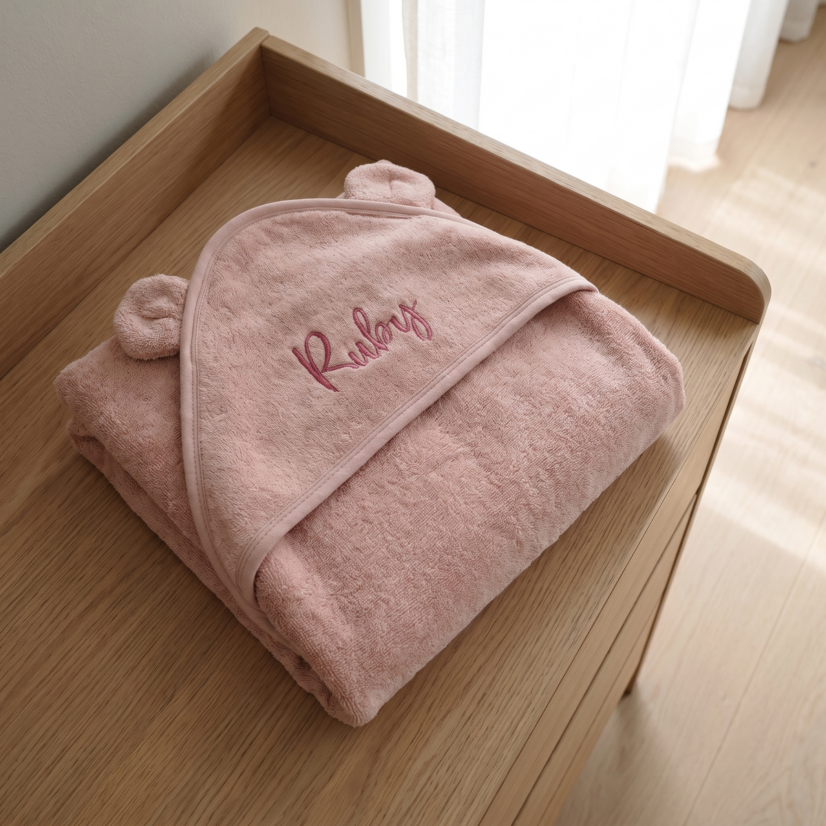 Personalised dusky pink organic cotton hooded baby towel with embroidered name