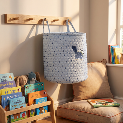 Large blue dinosaur storage bag filled with toys beside a child's bed