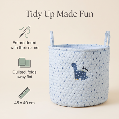 Child carrying a personalised blue dinosaur storage bag by its handles