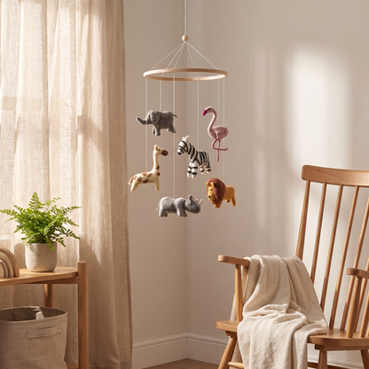 Close-up of felted jungle animals on the baby cot mobile