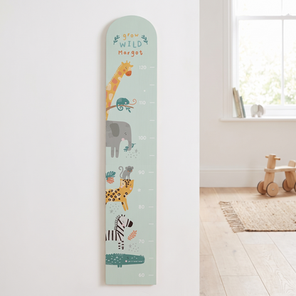 Personalised pastel green safari wooden height chart with printed name on a nursery wall