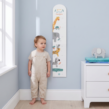 Close-up of safari animal illustrations and child's name on wooden height chart