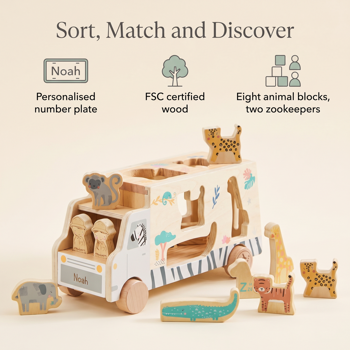 Toddler playing with a personalised wooden safari shape sorter in a playroom