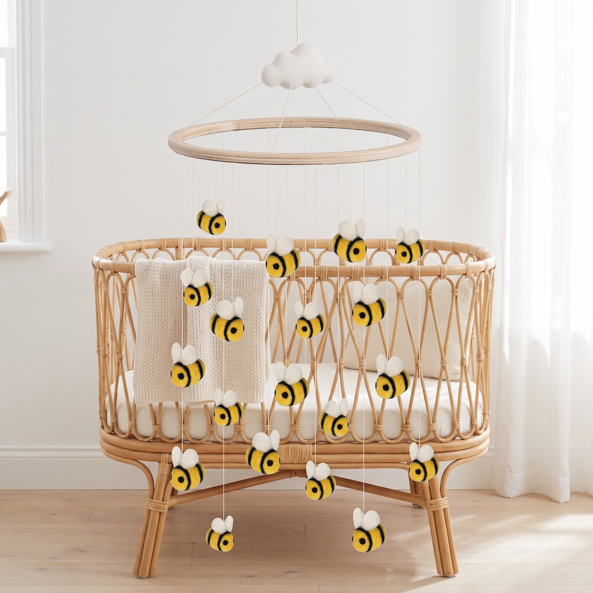 Bumblebee baby cot mobile with wool felt bees on a wooden frame