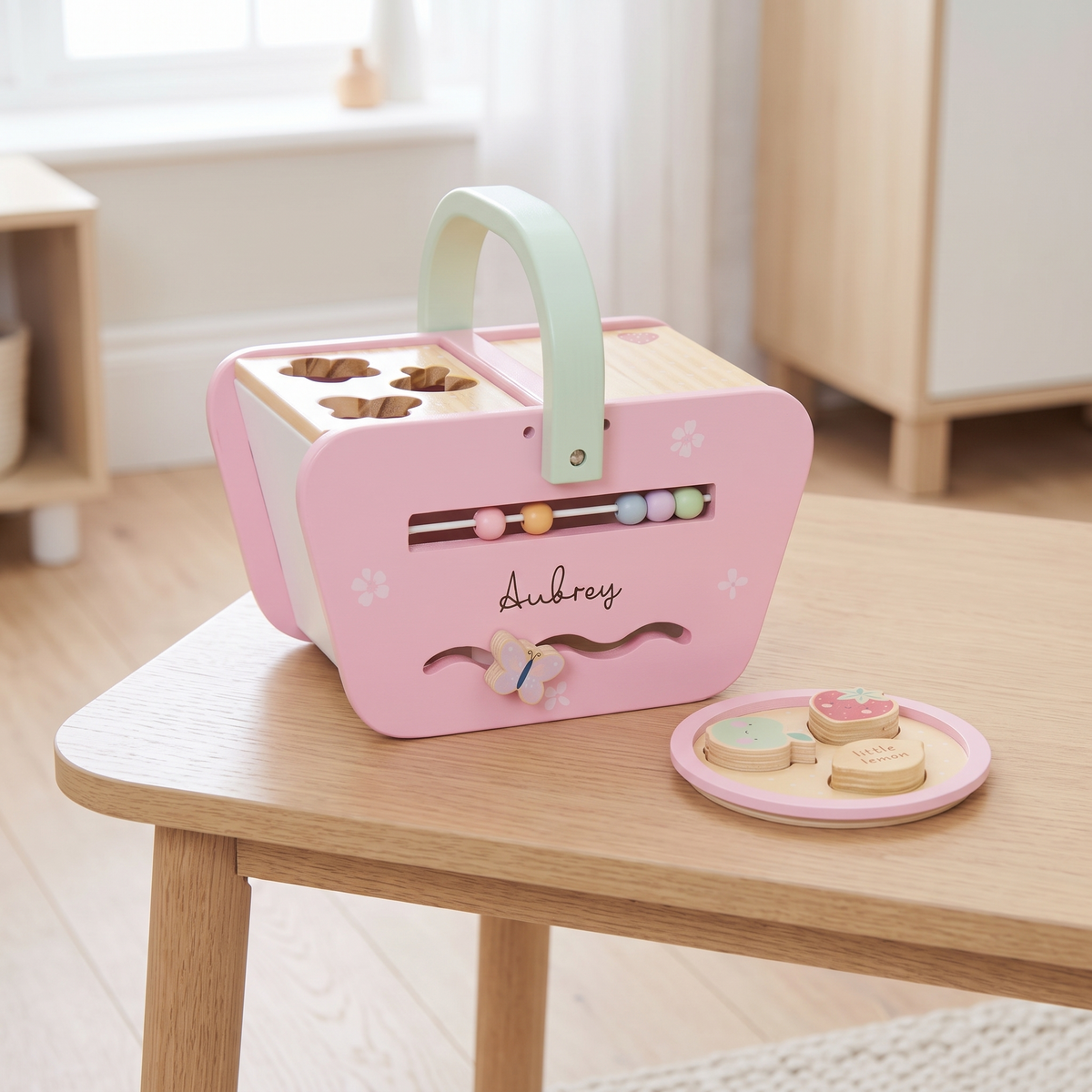 Personalised pink wooden picnic shape sorter with name in white script